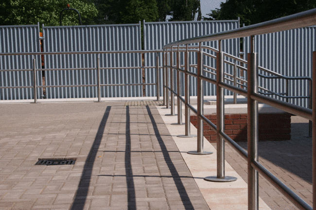 A stainless steel handrail standing outside a building