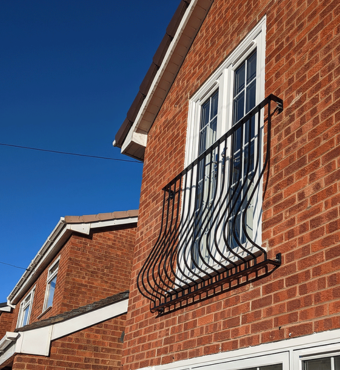 A steel Juliet Balcony covering the window of a house